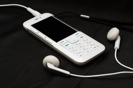 White mobile phone on black background