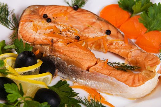 Salmon served with olives and lemon closeup photo