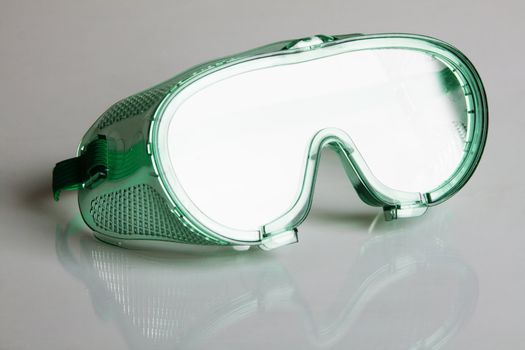 Safety glasses on gray background 