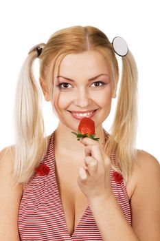 Beautiful girl tasting a strawberry, face portrait