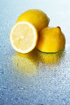 Lemon on wet surface, studio still life