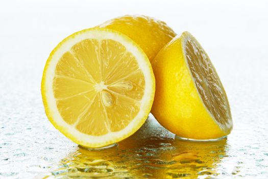 Lemon on wet surface, studio still life