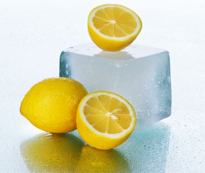 Lemon on wet surface, studio still life