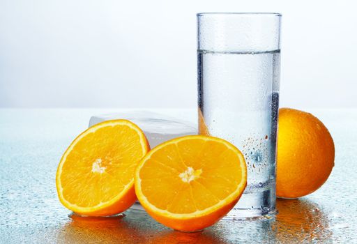 Orange slices with fresh water, studio still life