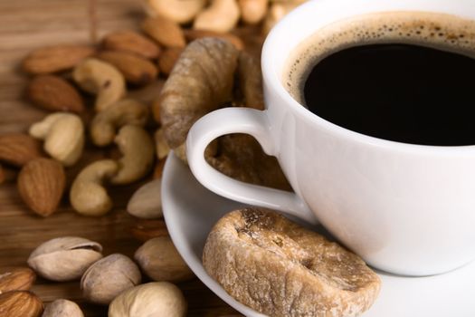 Closeup picture of coffee with nuts and dried fig still life 