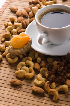 Coffee with nuts, fig and dried apricots still life