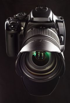 Professional digital camera on black background