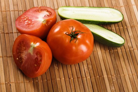 Tomatoes and cucumbers on a traditional bamboo pad