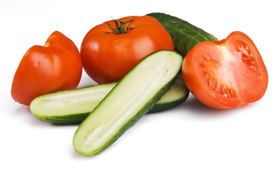 Tomatoes and cucumbers on white background