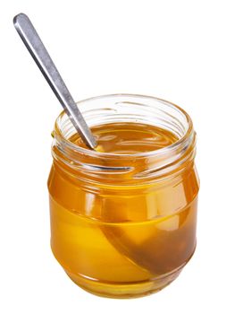 Jar of honey with spoon isolated on white