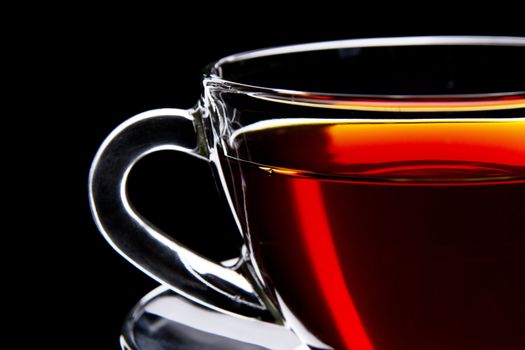 Cup of black tea isolated on black background