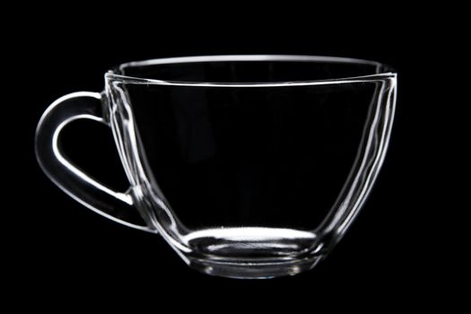 Glass tea cup isolated on black background