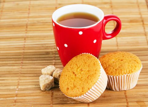 Cup of sweet tea with cakes and honey