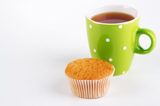 Cup of tea with cake on white background