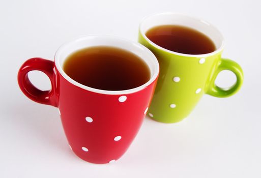 Two cups of tea on white background