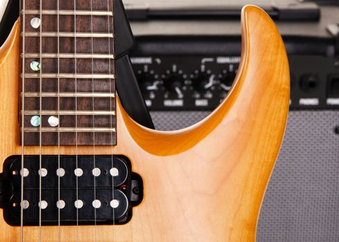 Electric guitar with amplifier, closeup photo