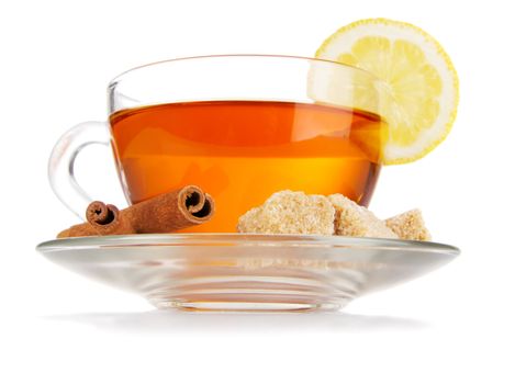 Glass cup of black tea with lemon, cinnamon and sugar, isolated on white