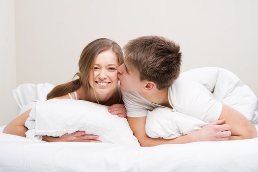 Young beautiful couple in bed