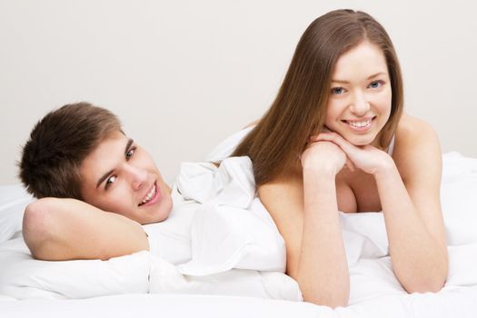 Young beautiful couple in bed