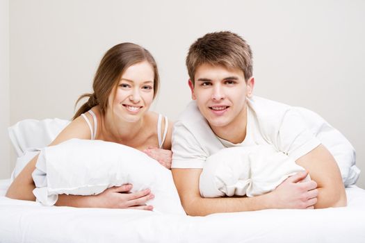 Young beautiful couple in bed