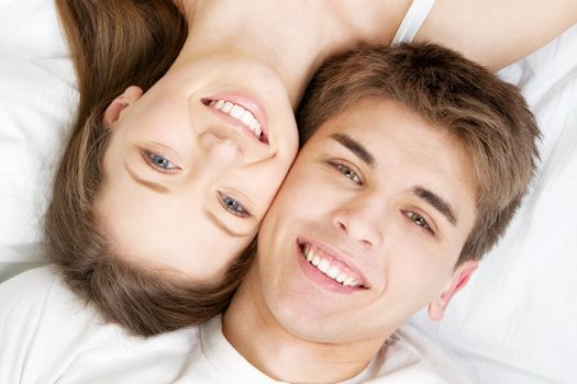 Beautiful young couple in bed, face portrait