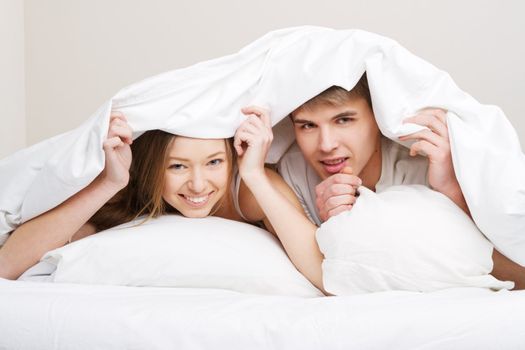 Young beautiful couple in bed