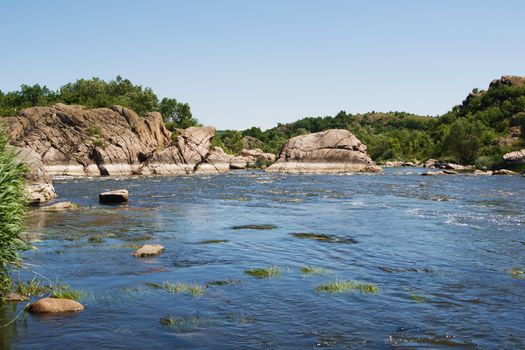 Rocky landscape with cliffs in background and water in front