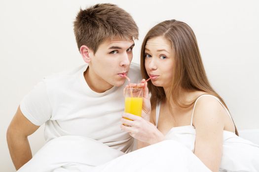 Young couple drinking juice in the morning