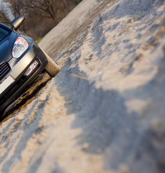 Trace of a car on sandy beach