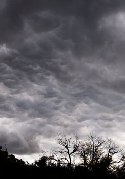 Dark stormy sky with silver gleams of sunlight