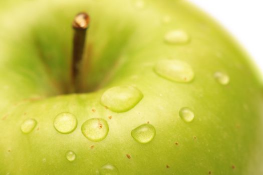 Green apple with waterdrops on its surface