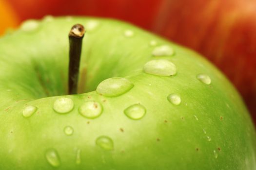 Green apple with waterdrops on its surface