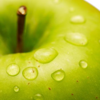 Green apple with waterdrops on its surface