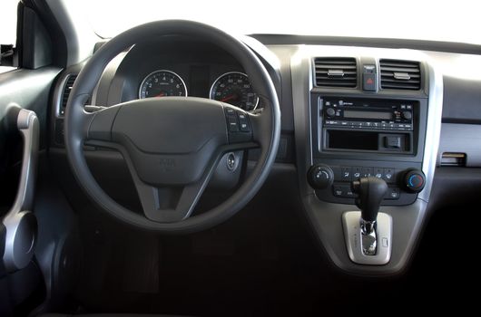 Interior of a car with view on steering wheel and dashboard