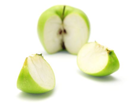 Cut green apple isolated on white background.