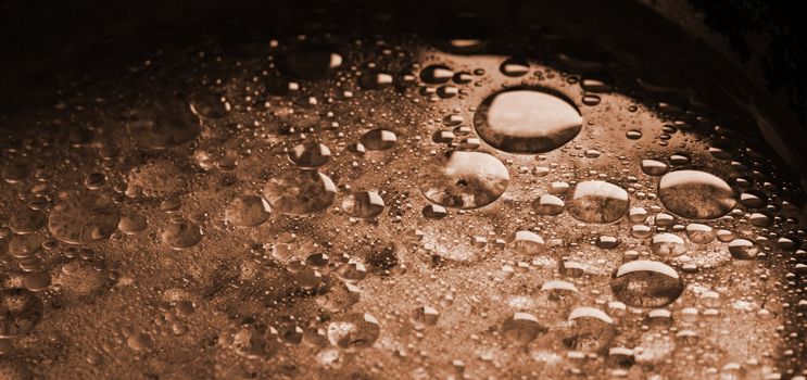Abstract image of oil drops in water, brown tint