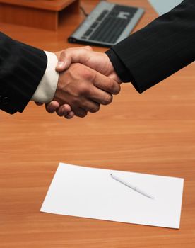 Successfull deal concept - handshake closeup photo.