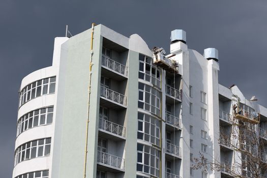 Steeplejacks working on a facade of a new building