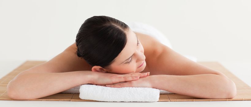Pretty dark-haired woman getting a spa treatment lying down