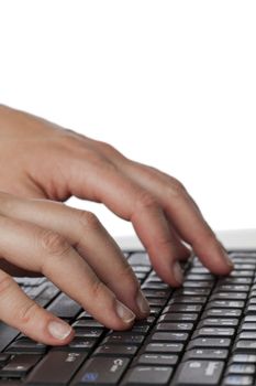 Close up image of human hand typing on laptop against white background  