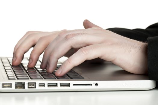 Close up image of human hand typing on laptop keyboard