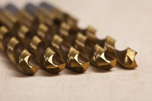 Macro image of Drill bits over a wooden background