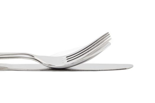 Cropped image of fork and knife against white background