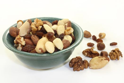 various nuts and raisins on a white background