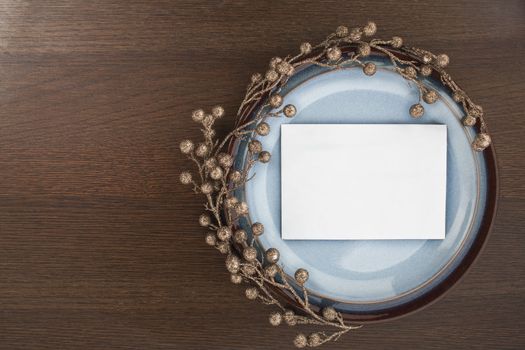 White envelope and decoration in a saucer