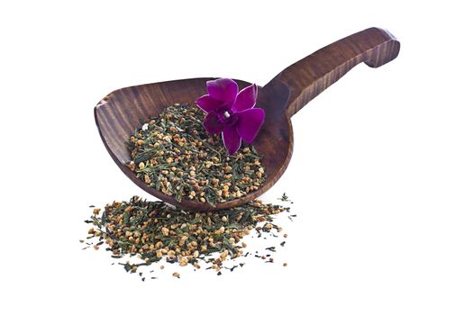 Dried tea leaves and pink flower with shovel isolated over white background