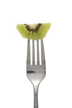 Close-up shot of kiwi fruit on fork against white background.