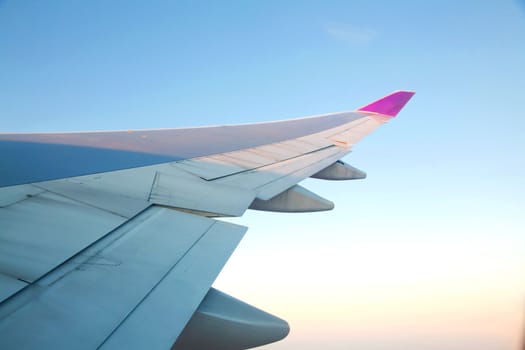 Sunrise with Airplanes wing from its windows with cloudscape