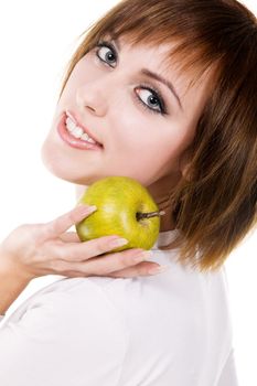 Portrait of a young beautiful woman with a green apple against white background 