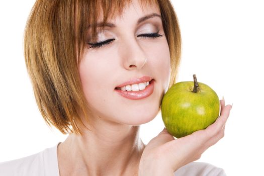 Closeup portrait of a young beautiful woman with a green apple against white background